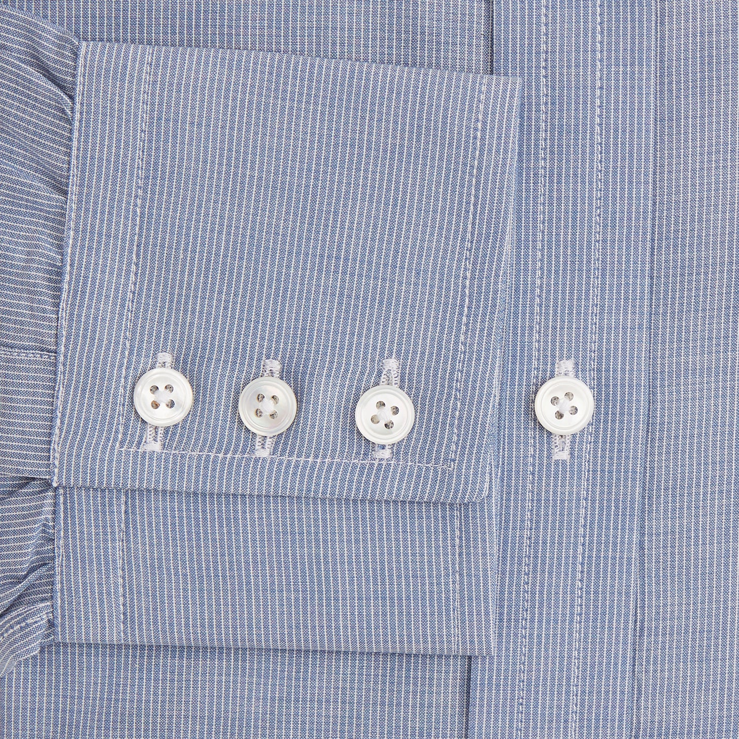 View 3 of product The Turnbull & Asser Blue Pencil Stripe Mayfair Shirt is crafted from organic cotton with a classic collar, white buttons, and buttoned cuffs. Shown laid flat on a white background.