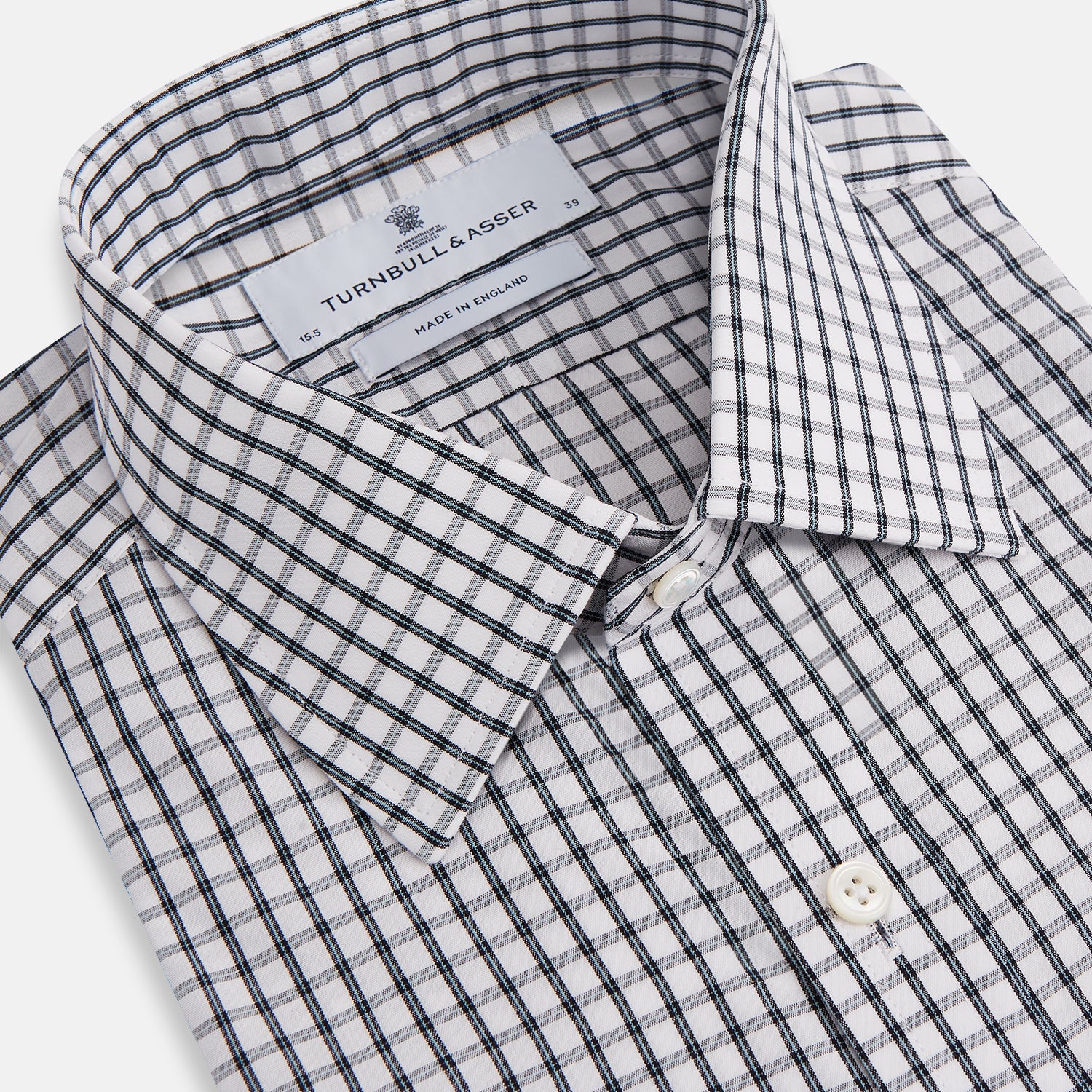 View 2 of product The Turnbull & Asser Midnight Blue Double Graph Check Mayfair Shirt features a pointed collar and buttoned cuffs. Crafted from breathable cotton, this stylish shirt ensures comfort and is shown against a white background.