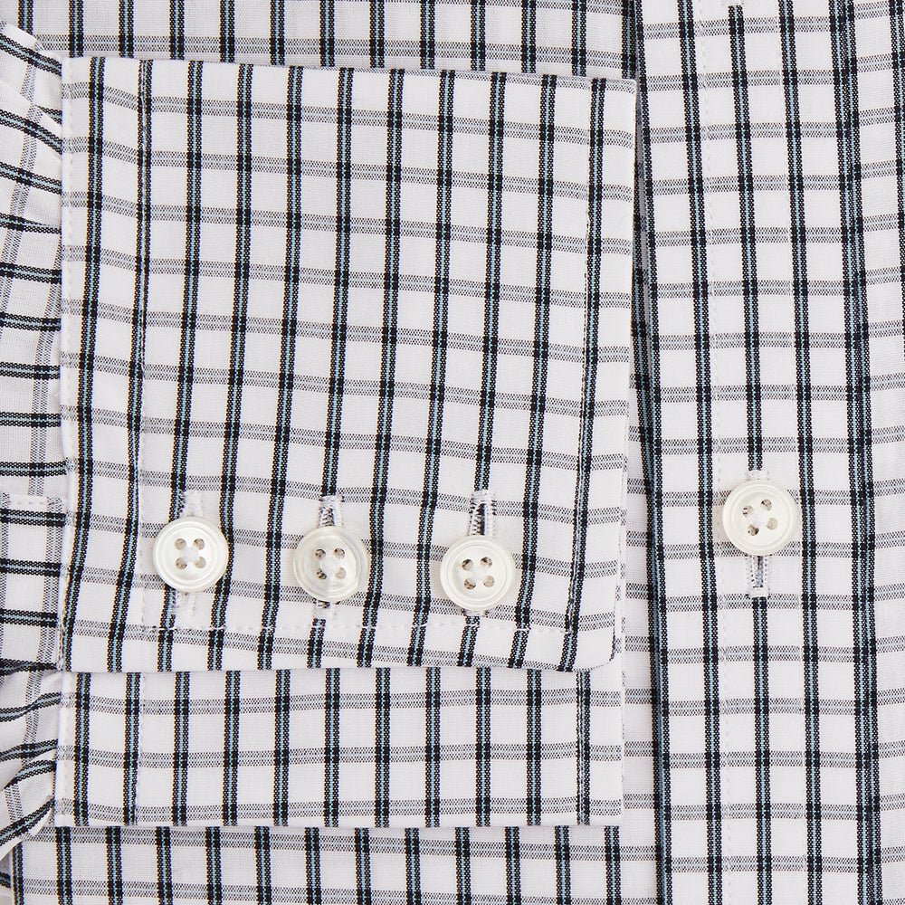 The Turnbull & Asser Midnight Blue Double Graph Check Mayfair Shirt features a pointed collar and buttoned cuffs. Crafted from breathable cotton, this stylish shirt ensures comfort and is shown against a white background.