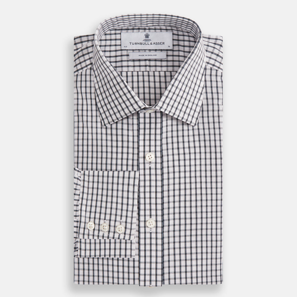 The Turnbull & Asser Midnight Blue Double Graph Check Mayfair Shirt features a pointed collar and buttoned cuffs. Crafted from breathable cotton, this stylish shirt ensures comfort and is shown against a white background.