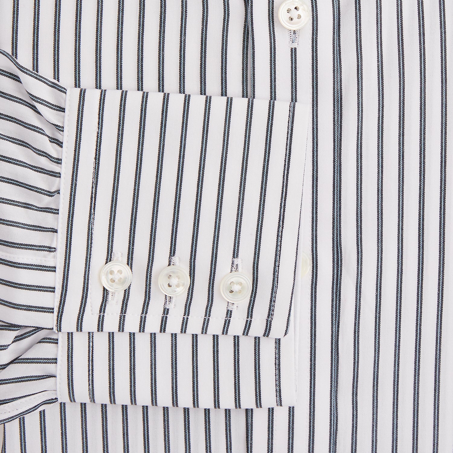 View 3 of product The Turnbull & Asser Midnight Blue Halo Stripe Mayfair Shirt features breathable cotton with black and white vertical stripes, a pointed T&A collar, and buttoned cuffs, displayed flat on a white background.