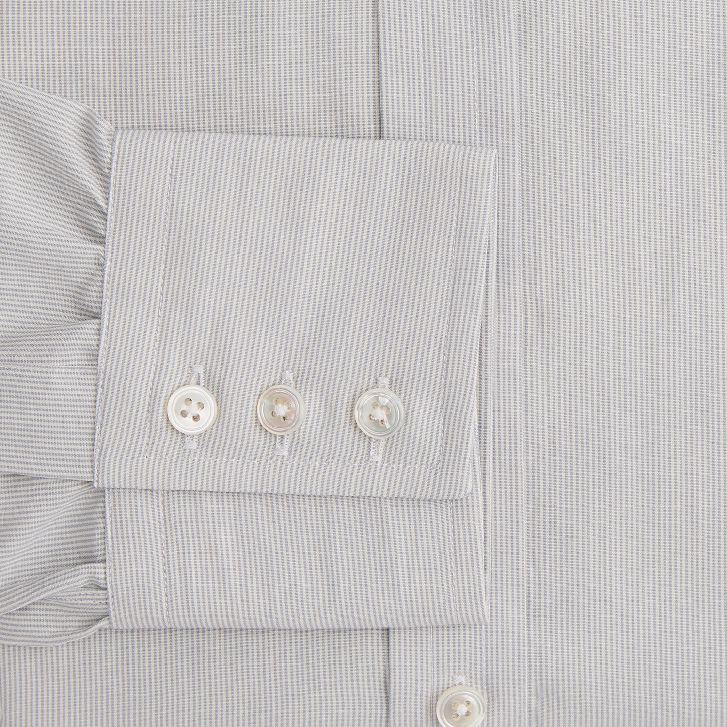 View 3 of product The Turnbull & Asser Pale Blue Fine Stripe Mayfair Shirt features a classic collar, white buttons, cuffs, a slightly curved hem, and subtle pale blue stripes for a formal tailored look. Displayed on a plain white background.
