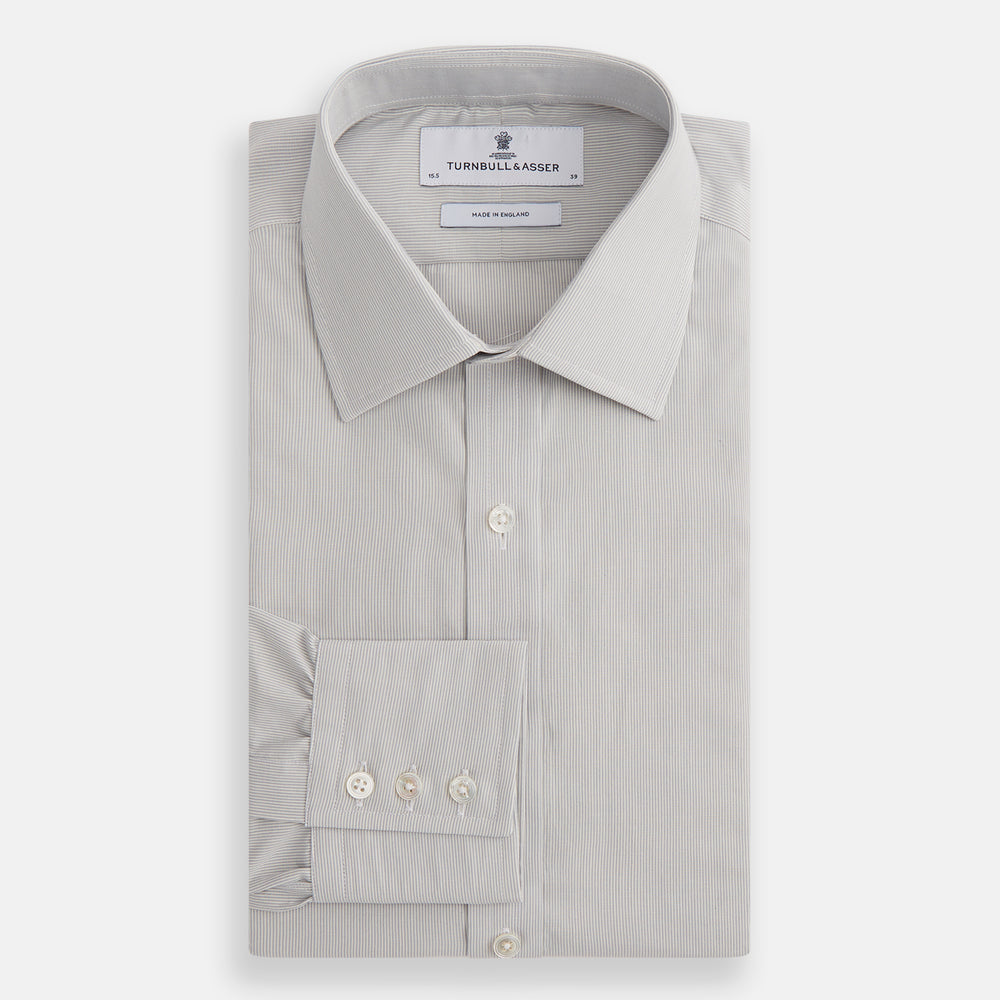The Turnbull & Asser Pale Blue Fine Stripe Mayfair Shirt features a classic collar, white buttons, cuffs, a slightly curved hem, and subtle pale blue stripes for a formal tailored look. Displayed on a plain white background.