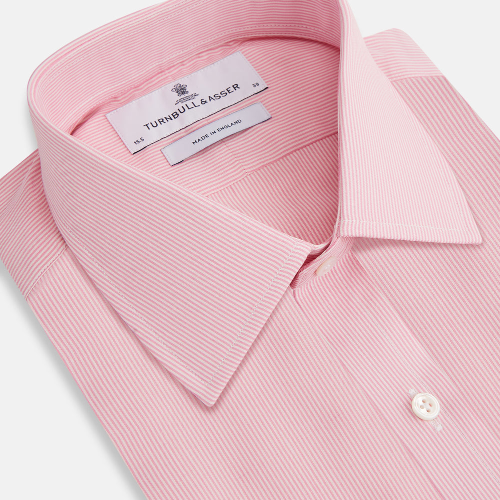 The Pink Fine Stripe Mayfair Shirt by Turnbull & Asser features fine white stripes, a classic T&A collar, visible white button, and is made from organic cotton in England.