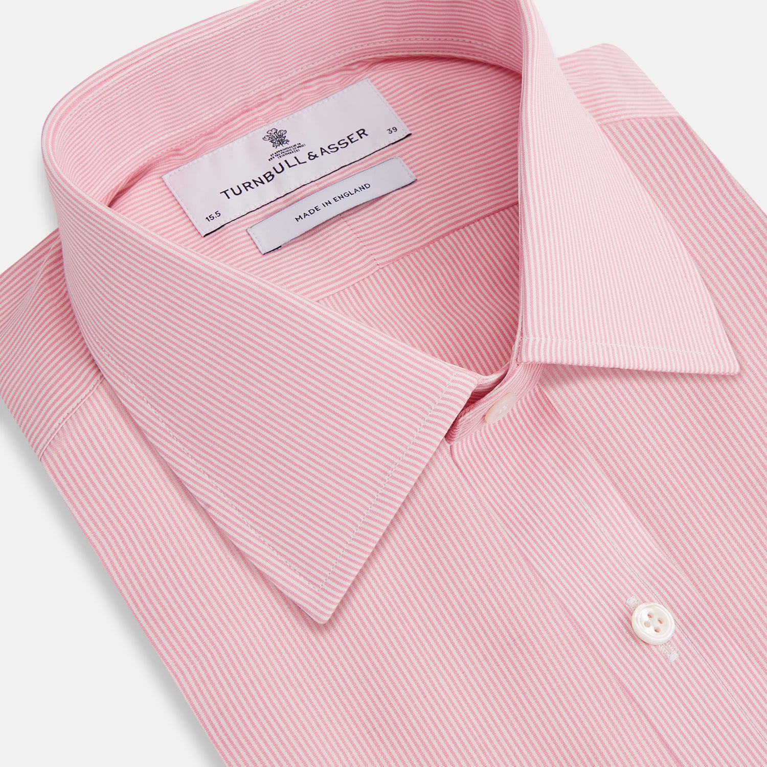 View 3 of product The Pink Fine Stripe Mayfair Shirt by Turnbull & Asser features fine white stripes, a classic T&A collar, visible white button, and is made from organic cotton in England.