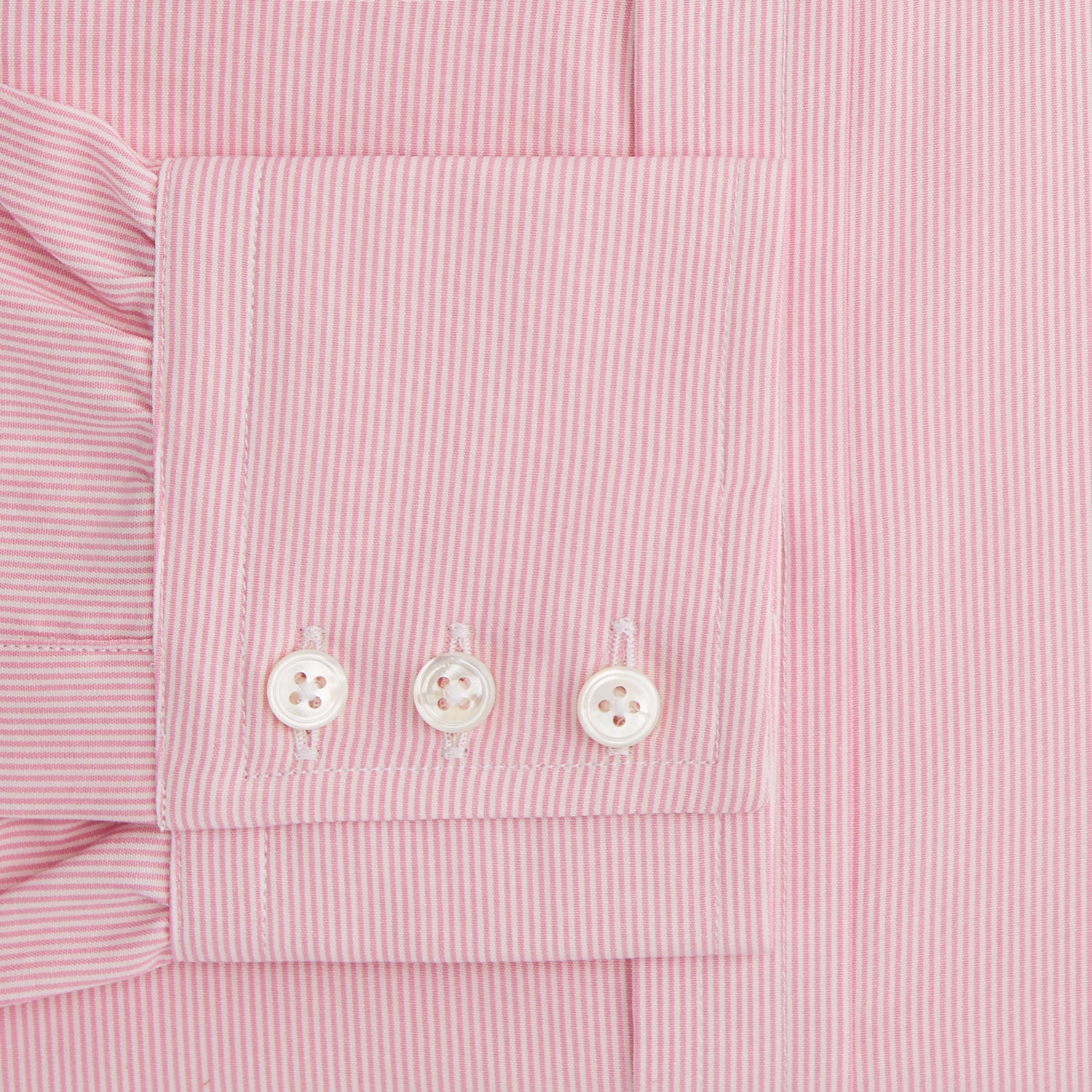View 4 of product The Pink Fine Stripe Mayfair Shirt by Turnbull & Asser features fine white stripes, a classic T&A collar, visible white button, and is made from organic cotton in England.