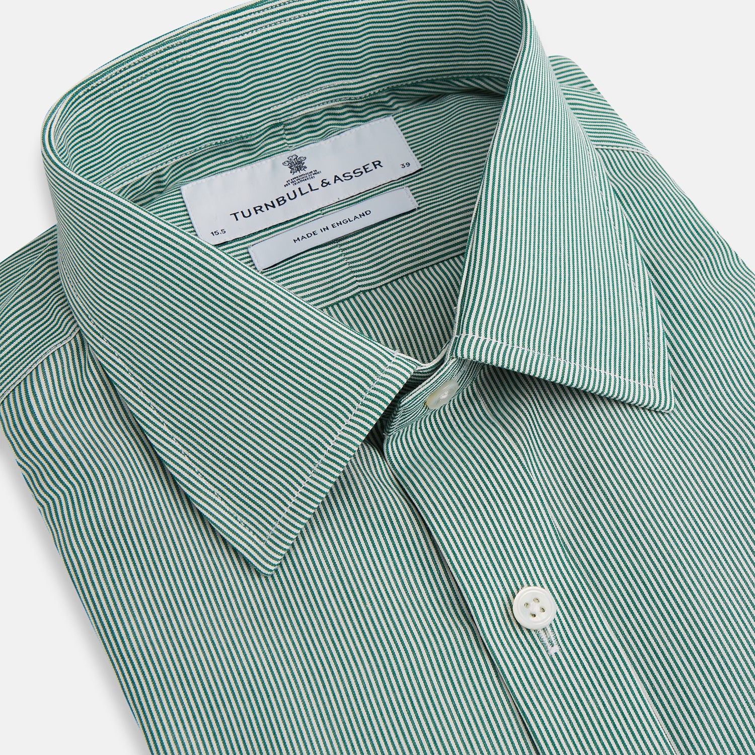 View 2 of product The Turnbull & Asser Green Fine Stripe Mayfair Shirt features long sleeves, a classic T&A collar, white buttons, and is showcased against a plain white background.