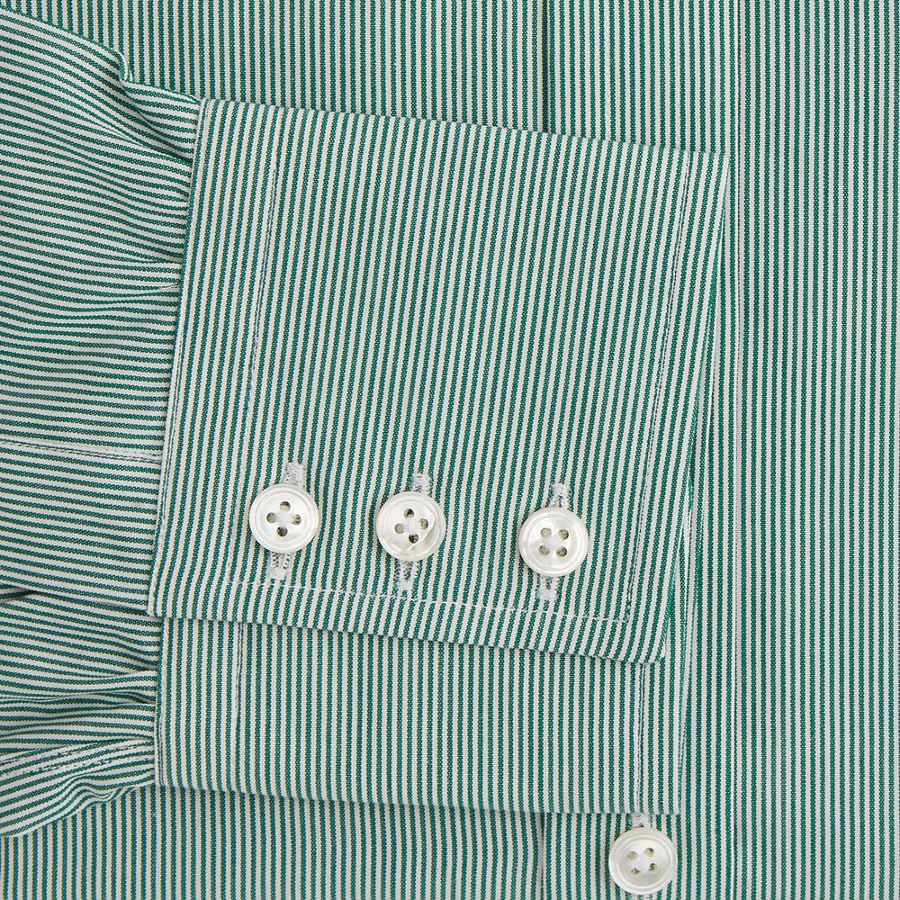 The Turnbull & Asser Green Fine Stripe Mayfair Shirt features long sleeves, a classic T&A collar, white buttons, and is showcased against a plain white background.