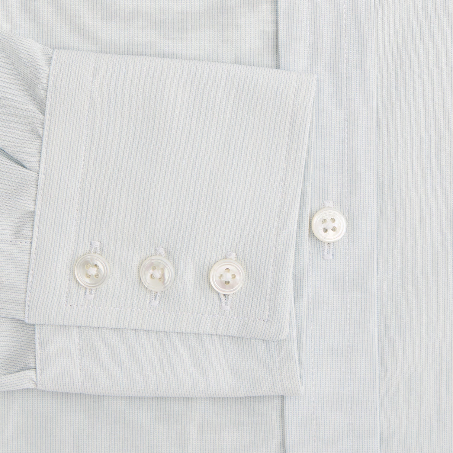 View 4 of product Pale Blue Pencil Stripe Mayfair Shirt by Turnbull & Asser featuring a classic collar, white buttons, and cuffed long sleeves, displayed flat on a white background.