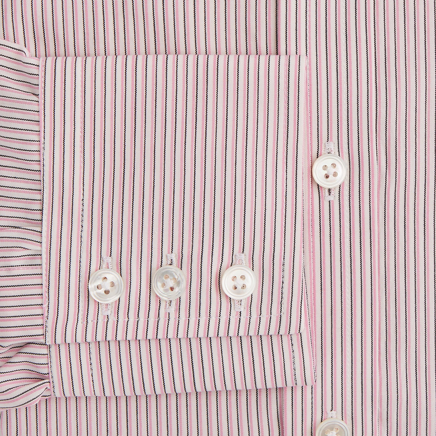 View 3 of product The Turnbull & Asser Pink Fine Shadow Stripe Mayfair Shirt is a long-sleeved button-up with a classic T&A collar, crafted from pure cotton and featuring thin pink and white vertical stripes, shown on a plain white background.