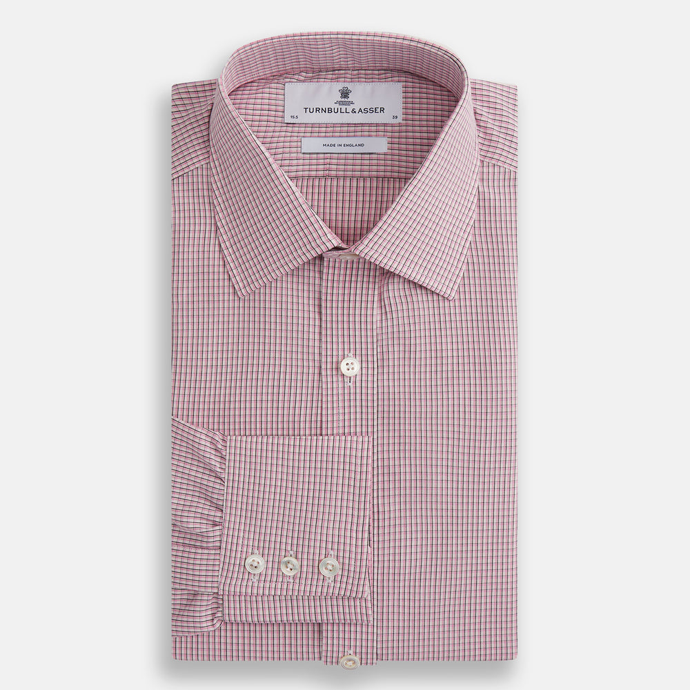 The Turnbull & Asser Pink Fine Graph Check Mayfair Shirt features long sleeves, breathable cotton, a pointed collar, 3-button cuffs, white buttons, and a red and white check pattern—shown on a plain white background.