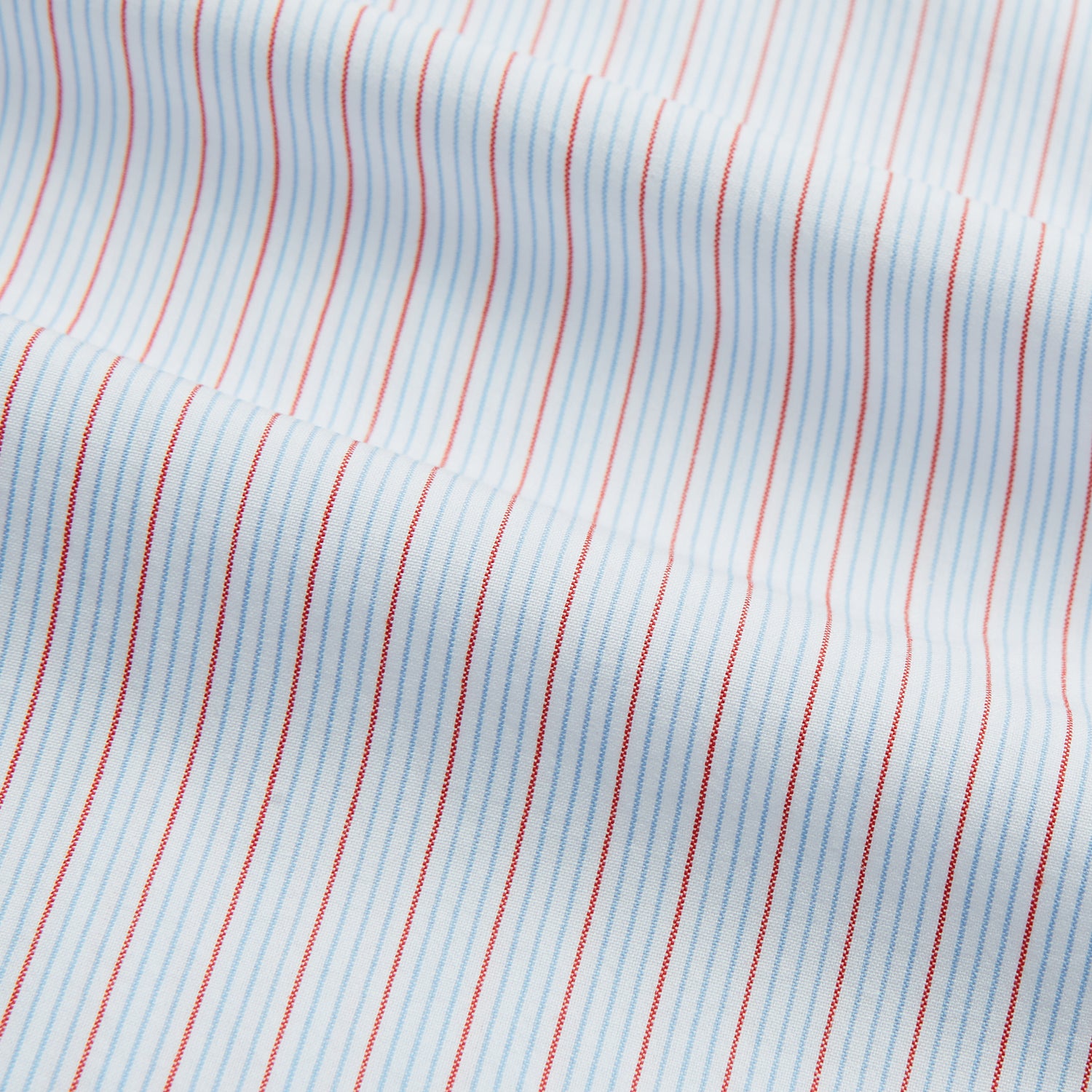View 5 of product Red Multi Pinstripe Mayfair Shirt by Turnbull & Asser, featuring colorful vertical pinstripes and a classic T&A collar, crafted from soft organic cotton, shown laid flat on a white background.