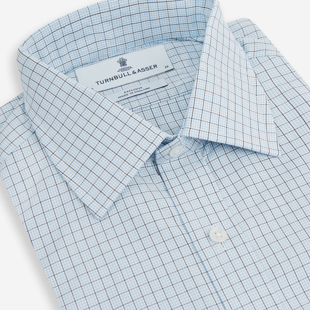 The Blue Multi Graph Check Mayfair Shirt by Turnbull & Asser features long sleeves, a classic T&A collar, chest pocket, and is crafted from breathable cotton, shown on a white background.