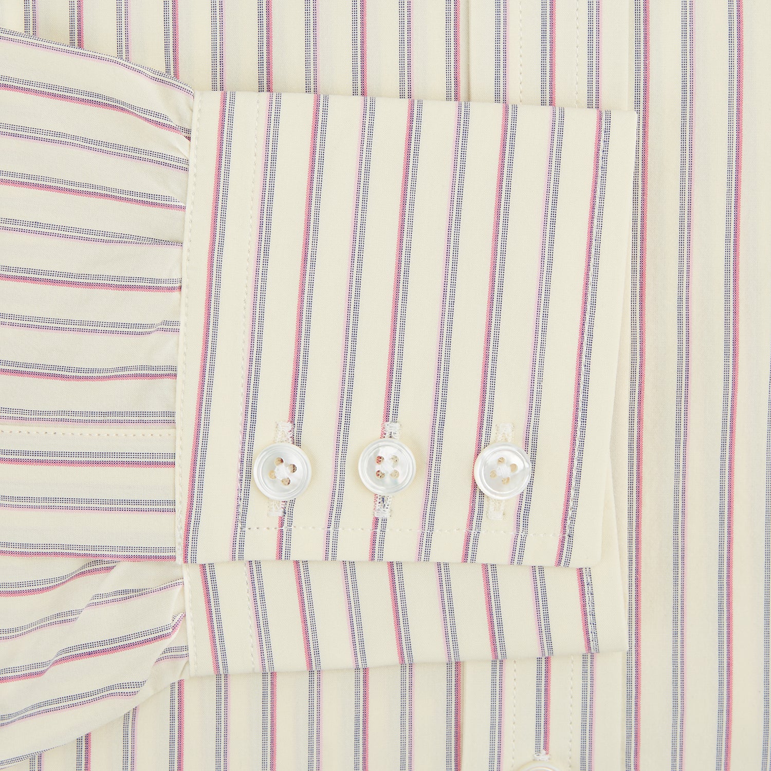View 3 of product The Turnbull & Asser Pink Double Stripe Mayfair Shirt features long sleeves, a pointed T&A collar, and buttoned cuffs, crafted from organic cotton with pink double stripes on white, shown laid flat against a light background.