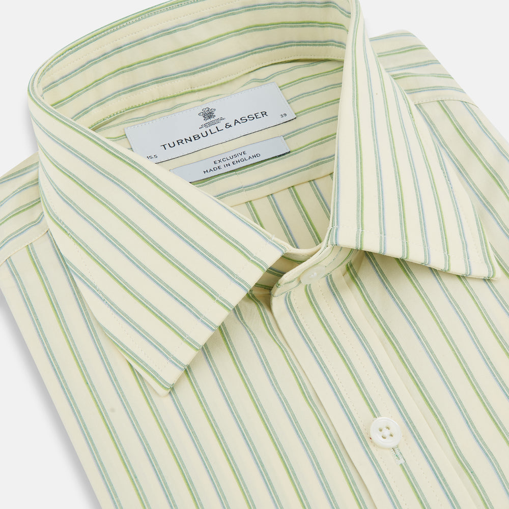 The Green Double Stripe Mayfair Shirt by Turnbull & Asser features light green and white vertical stripes, long sleeves, a T&A collar, and buttoned cuffs. Made from organic cotton and shown laid flat on a white background.
