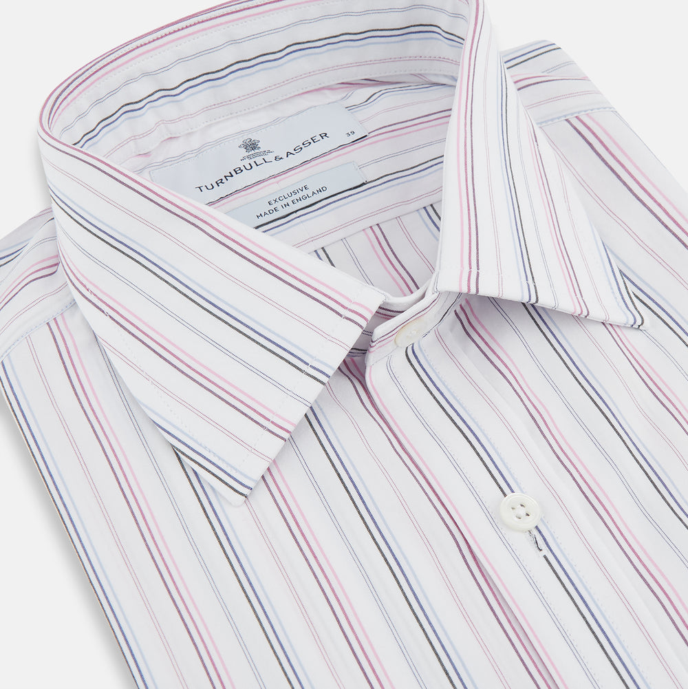 The Turnbull & Asser Purple and Blue Multi Stripe Mayfair Shirt features long sleeves, a classic T&A collar, buttoned cuffs, tailored fit, and organic cotton construction. Displayed on a plain white background.