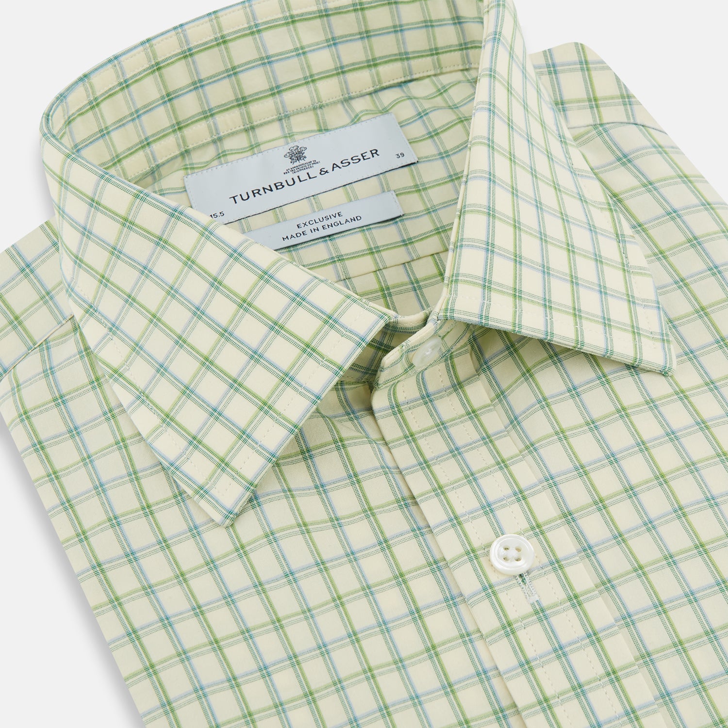 View 2 of product The Turnbull & Asser Green Multi Check Mayfair Shirt features a light green and white checkered pattern, long sleeves, a collar, and buttoned cuffs. Displayed on a white background.