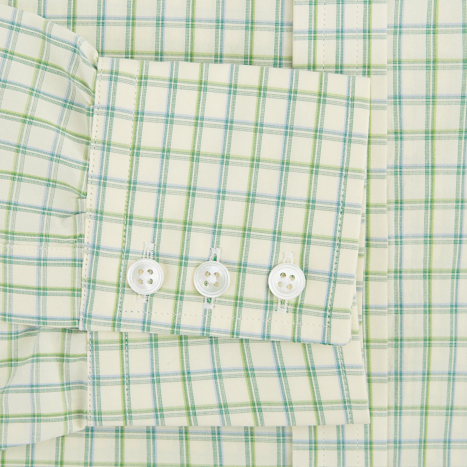 View 3 of product The Turnbull & Asser Green Multi Check Mayfair Shirt features a light green and white checkered pattern, long sleeves, a collar, and buttoned cuffs. Displayed on a white background.
