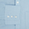 View 3 of product The Blue Cotton Cashmere Chelsea Shirt by Turnbull & Asser, a light blue long-sleeve button-up with a chest pocket, crafted from soft cotton and cashmere, is shown laid flat on a white background.