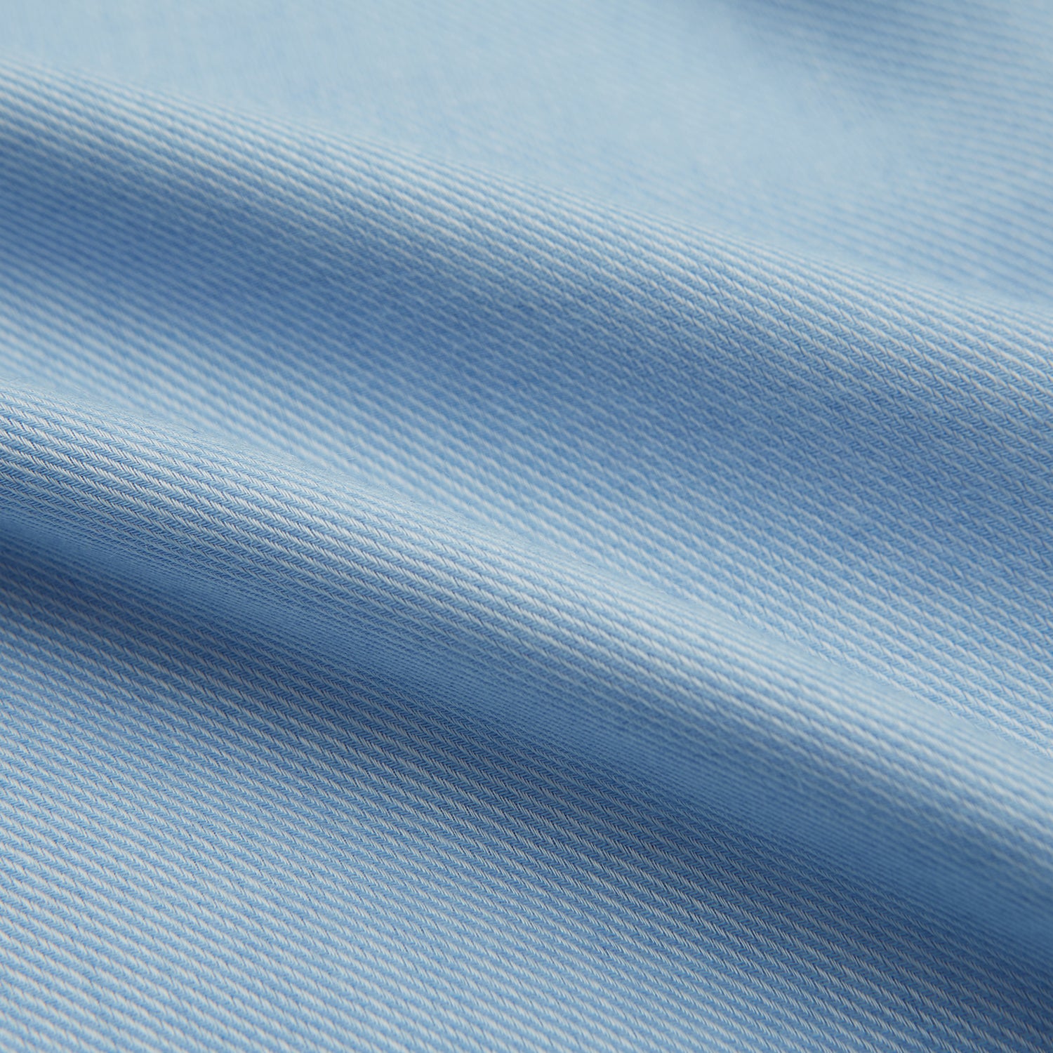 View 6 of product The Blue Cotton Cashmere Chelsea Shirt by Turnbull & Asser, a light blue long-sleeve button-up with a chest pocket, crafted from soft cotton and cashmere, is shown laid flat on a white background.