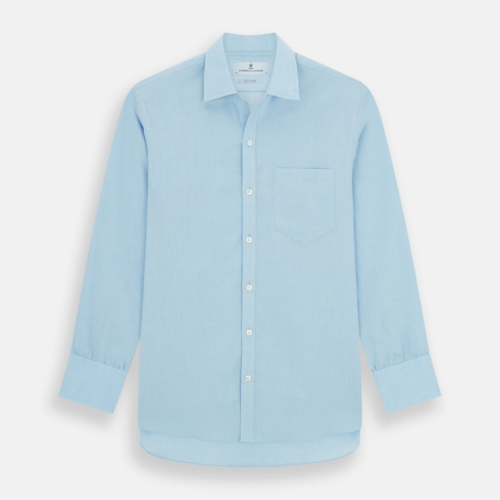 The Blue Cotton Cashmere Chelsea Shirt by Turnbull & Asser, a light blue long-sleeve button-up with a chest pocket, crafted from soft cotton and cashmere, is shown laid flat on a white background.