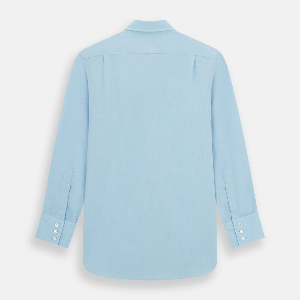 The Blue Cotton Cashmere Chelsea Shirt by Turnbull & Asser, a light blue long-sleeve button-up with a chest pocket, crafted from soft cotton and cashmere, is shown laid flat on a white background.