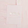 View 3 of product The Turnbull & Asser Pale Pink Cotton Cashmere Chelsea Shirt features long sleeves, a chest pocket, spread collar, and buttoned cuffs. Crafted from a luxurious cotton-cashmere blend, it's shown laid flat on a white background.