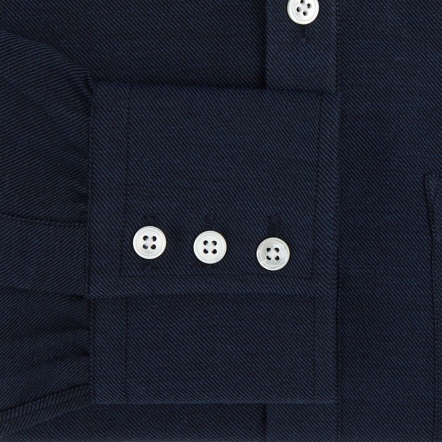 View 3 of product The Turnbull & Asser Navy Cotton Cashmere Chelsea Shirt features long sleeves, a classic collar, front chest pocket, and white buttons, shown laid flat on a white background.