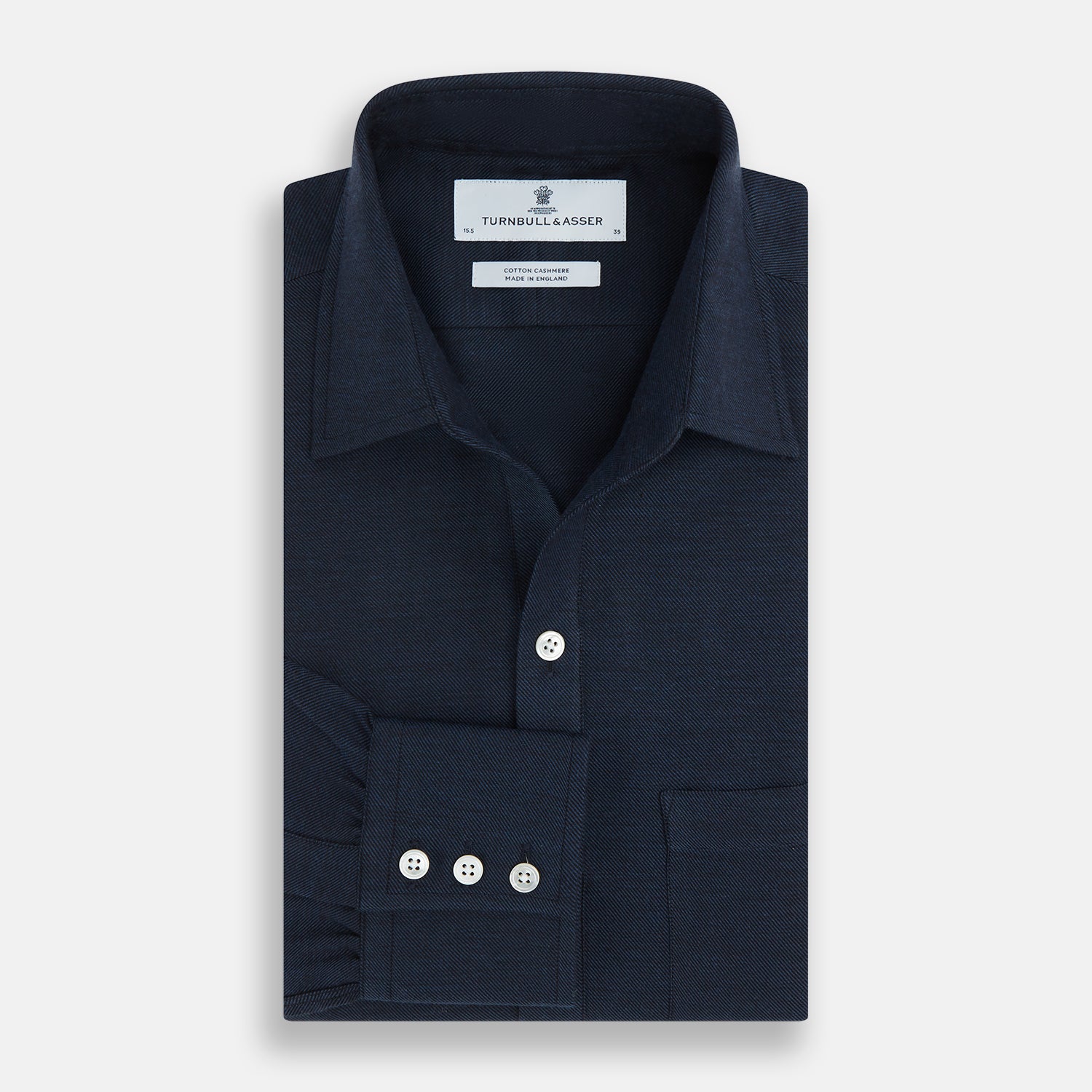 View 4 of product The Turnbull & Asser Navy Cotton Cashmere Chelsea Shirt features long sleeves, a classic collar, front chest pocket, and white buttons, shown laid flat on a white background.
