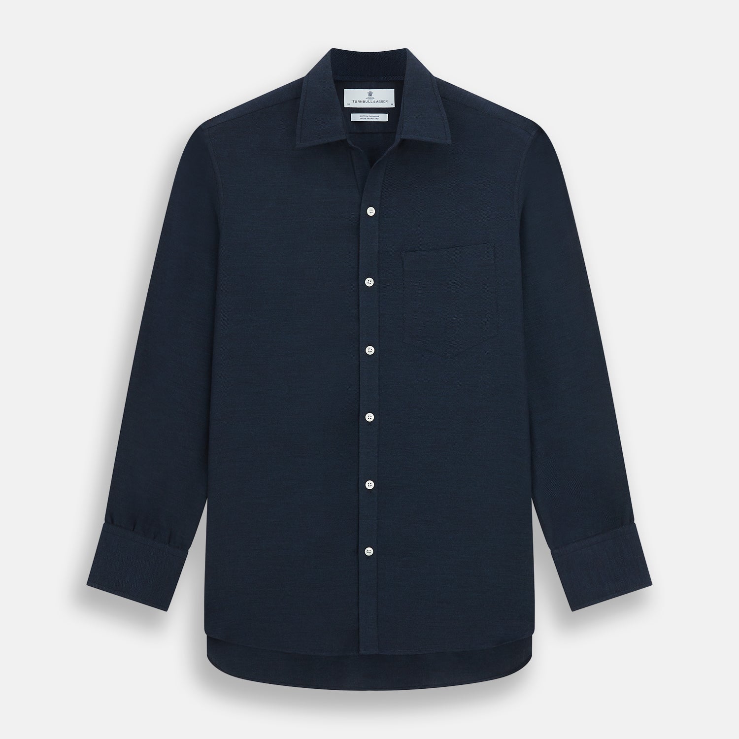View 1 of product The Turnbull & Asser Navy Cotton Cashmere Chelsea Shirt features long sleeves, a classic collar, front chest pocket, and white buttons, shown laid flat on a white background.
