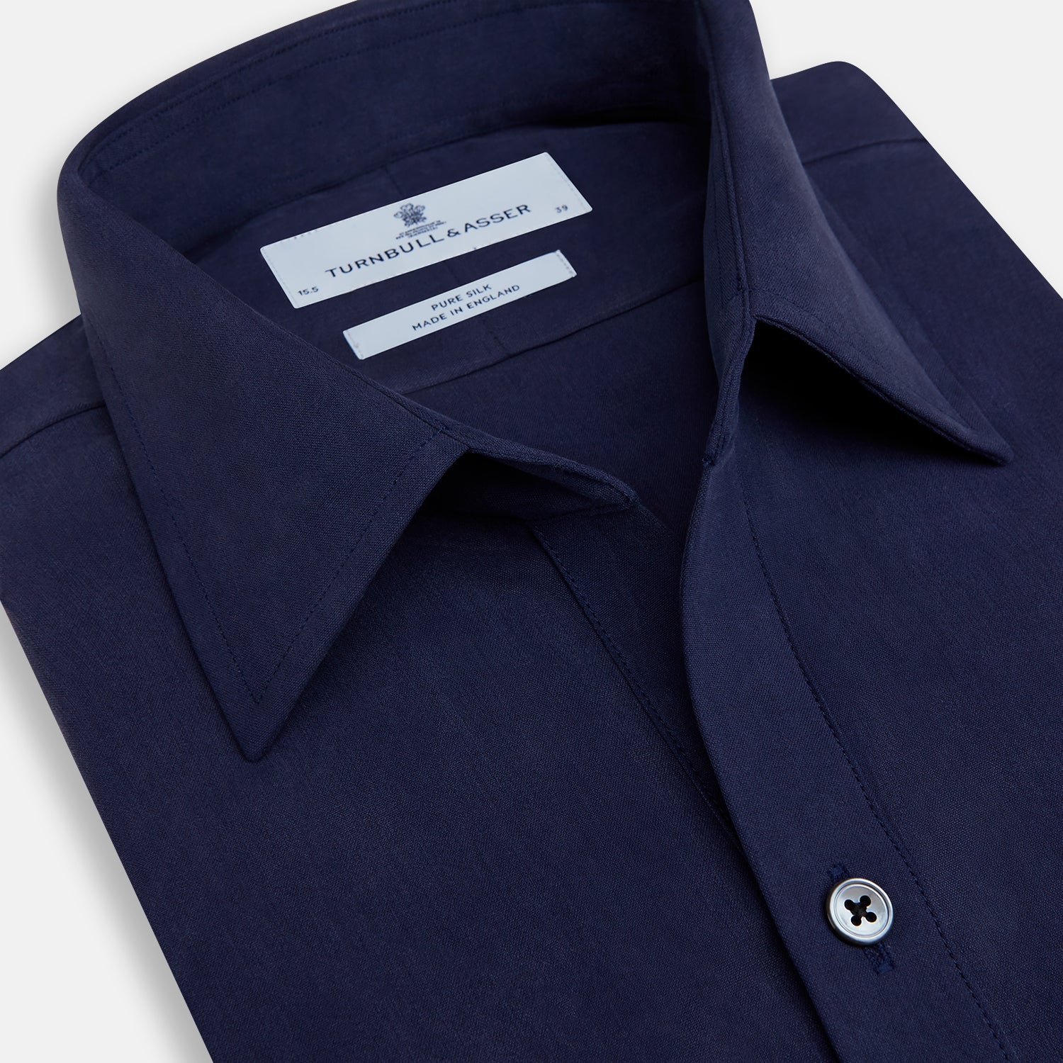 View 2 of product The Navy Silk Chelsea Shirt by Turnbull & Asser features a long sleeve, collar, single chest pocket, and a refined Chelsea fit, displayed against a white background.