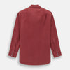 View 3 of product The Turnbull & Asser Burgundy Silk Chelsea Shirt is a long-sleeve, button-up top with a single chest pocket, shown on a white background.