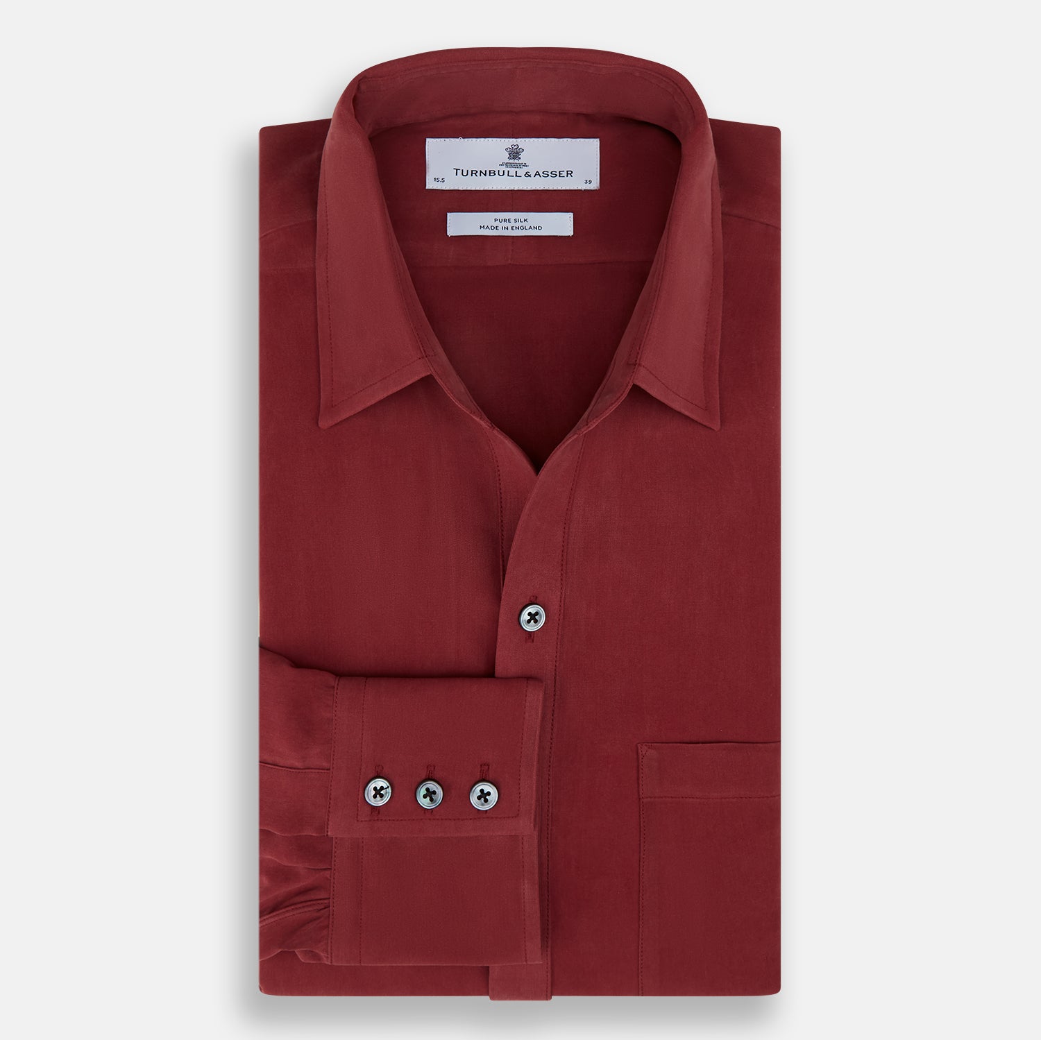 View 5 of product The Turnbull & Asser Burgundy Silk Chelsea Shirt is a long-sleeve, button-up top with a single chest pocket, shown on a white background.