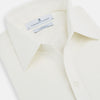View 2 of product The Turnbull & Asser Cream Silk Chelsea Shirt is an elegant white long-sleeve, button-up silk shirt with a single chest pocket, shown against a plain white background.