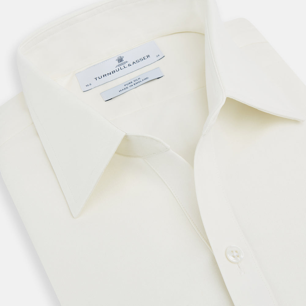 The Turnbull & Asser Cream Silk Chelsea Shirt is an elegant white long-sleeve, button-up silk shirt with a single chest pocket, shown against a plain white background.