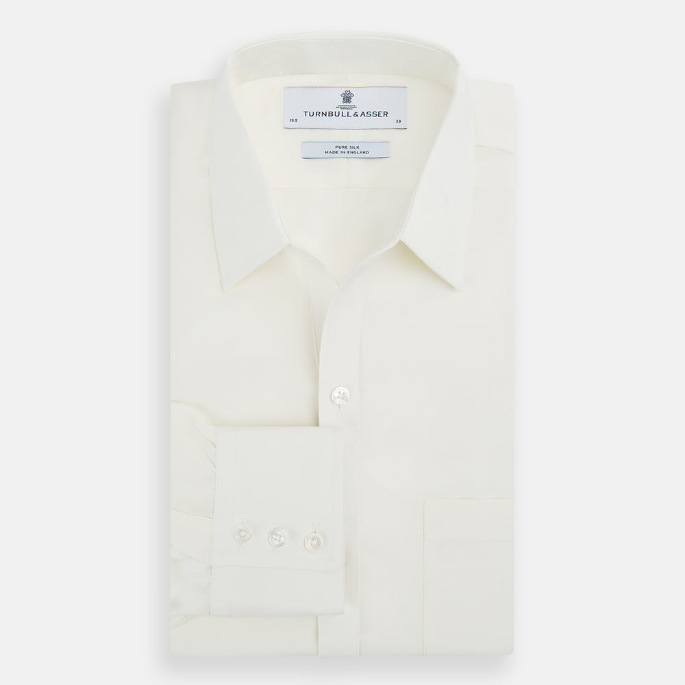 The Turnbull & Asser Cream Silk Chelsea Shirt is an elegant white long-sleeve, button-up silk shirt with a single chest pocket, shown against a plain white background.