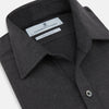 View 2 of product The Charcoal Chelsea Shirt by Turnbull & Asser is a long-sleeve, collared shirt in charcoal gray with a single chest pocket, offering smart-casual style, shown on a plain white background.