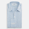 View 5 of product The Turnbull & Asser Blue Multi Track Stripe Chelsea Shirt features long sleeves, a light blue multi-stripe design, a chest pocket, open collar, and buttoned cuffs, shown laid flat on a white background.