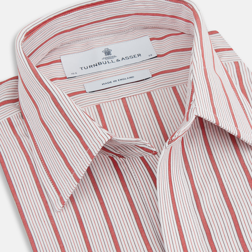 The Turnbull & Asser Red Multi Track Stripe Chelsea Shirt features a classic open collar, long sleeves, red vertical stripes on white, and a left chest pocket—laid flat against a plain background.