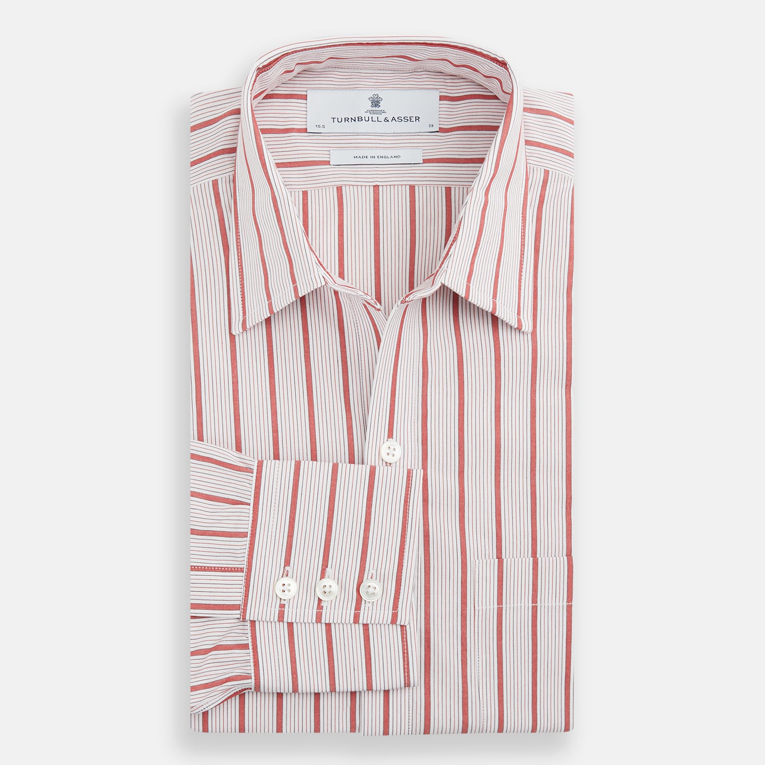 View 5 of product The Turnbull & Asser Red Multi Track Stripe Chelsea Shirt features a classic open collar, long sleeves, red vertical stripes on white, and a left chest pocket—laid flat against a plain background.