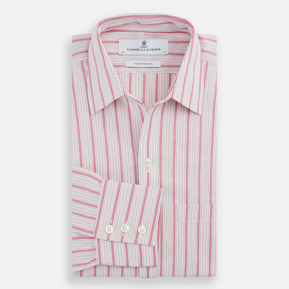 The Turnbull & Asser Pink Multi Track Stripe Chelsea Shirt features long sleeves, an open T&A collar, a left chest pocket, and buttoned cuffs, shown laid flat on a white background.