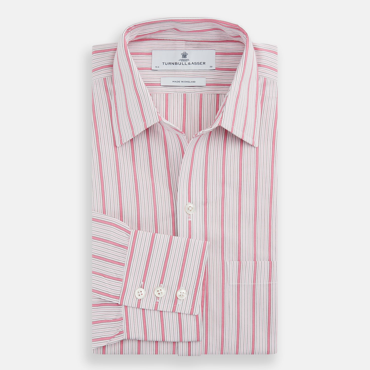 View 5 of product The Turnbull & Asser Pink Multi Track Stripe Chelsea Shirt features long sleeves, an open T&A collar, a left chest pocket, and buttoned cuffs, shown laid flat on a white background.