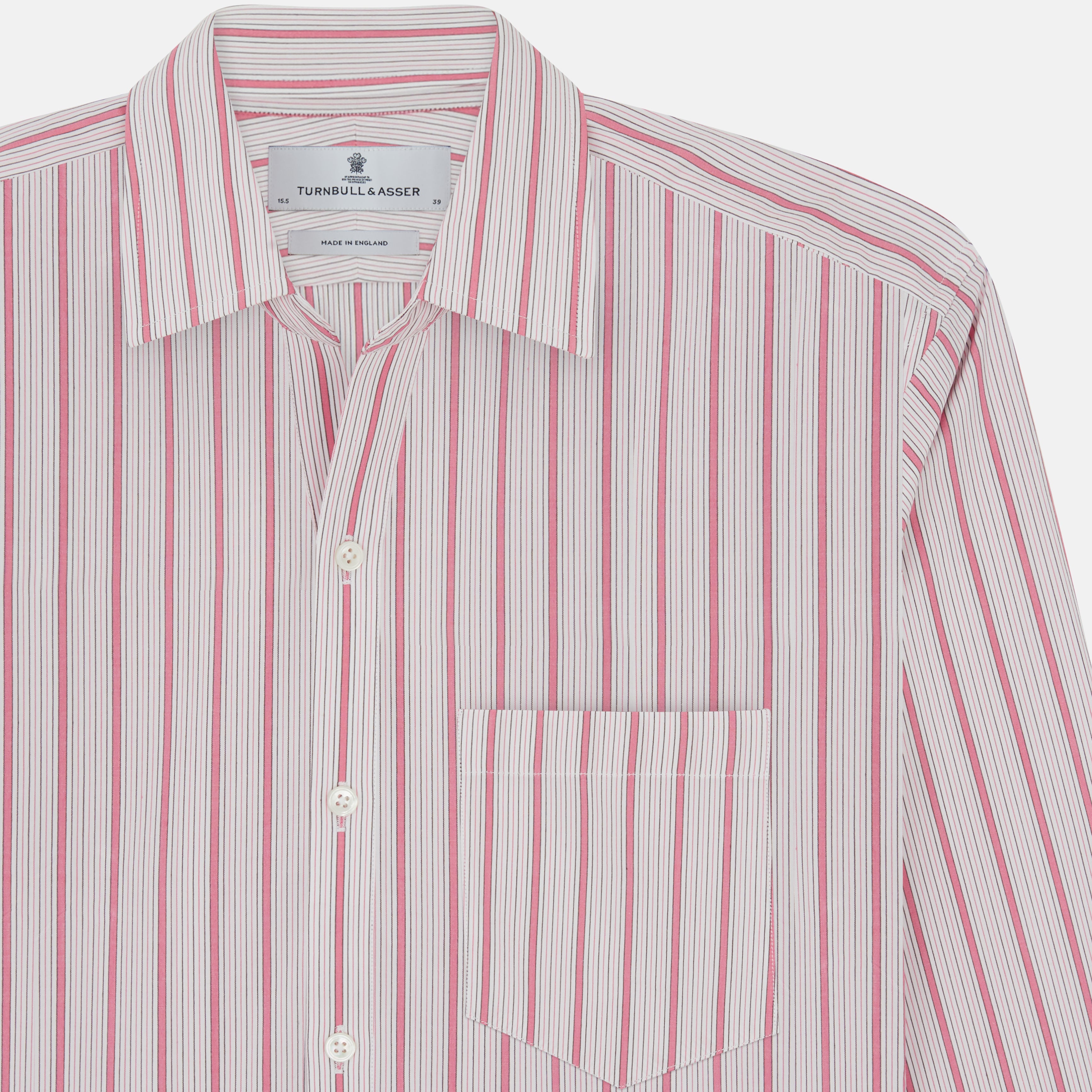 View 4 of product The Turnbull & Asser Pink Multi Track Stripe Chelsea Shirt features long sleeves, an open T&A collar, a left chest pocket, and buttoned cuffs, shown laid flat on a white background.
