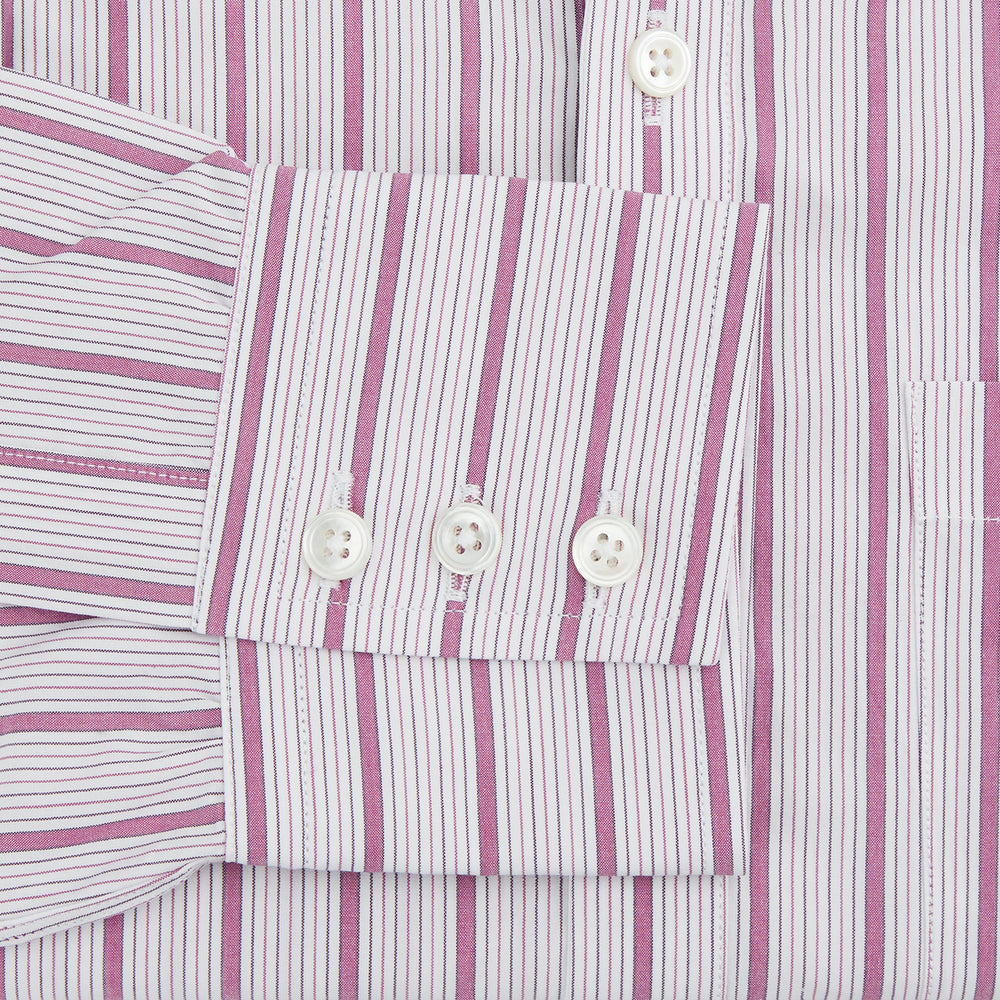 The Purple Multi Track Stripe Chelsea Shirt by Turnbull & Asser features a long-sleeve button-up design with an open Chelsea collar, purple background, vertical multi track stripes, front left pocket, and classic buttoned cuffs.