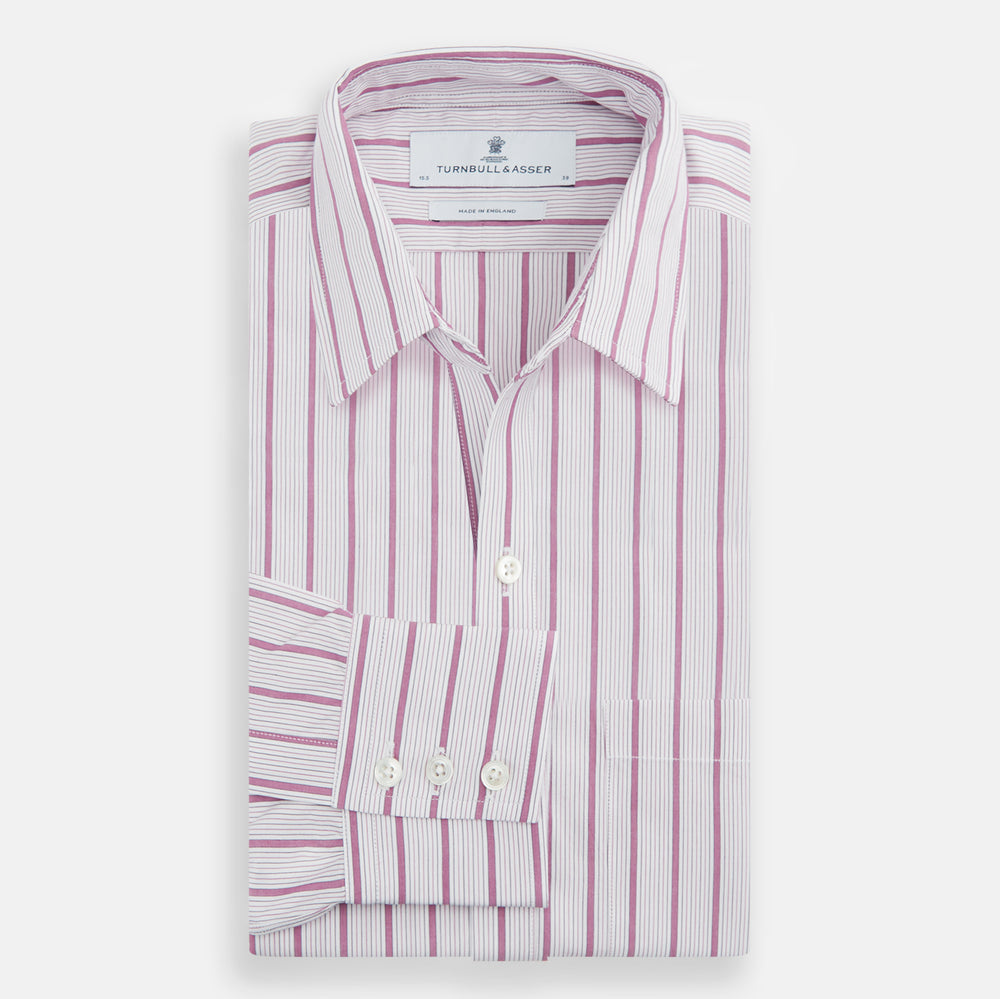 The Purple Multi Track Stripe Chelsea Shirt by Turnbull & Asser features a long-sleeve button-up design with an open Chelsea collar, purple background, vertical multi track stripes, front left pocket, and classic buttoned cuffs.