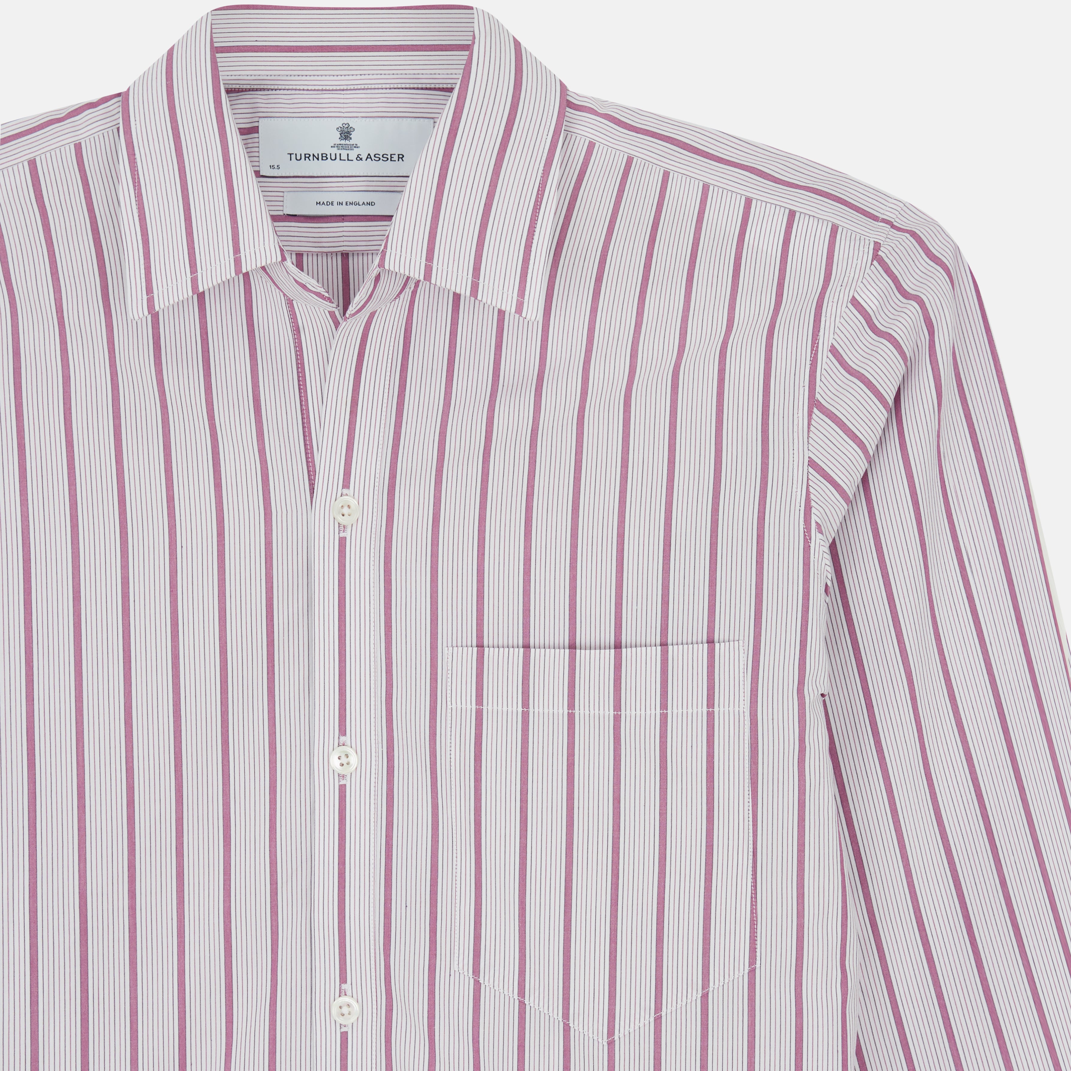 View 4 of product The Purple Multi Track Stripe Chelsea Shirt by Turnbull & Asser features a long-sleeve button-up design with an open Chelsea collar, purple background, vertical multi track stripes, front left pocket, and classic buttoned cuffs.