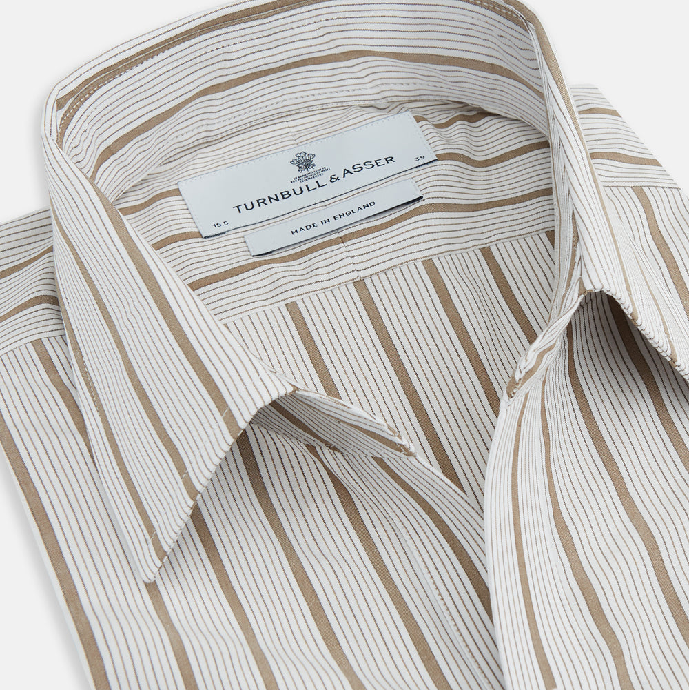 The Turnbull & Asser Brown Multi Track Stripe Chelsea Shirt features long sleeves, multi-track tan stripes, a left chest pocket, and an open T&A collar, shown laid flat on a white background.