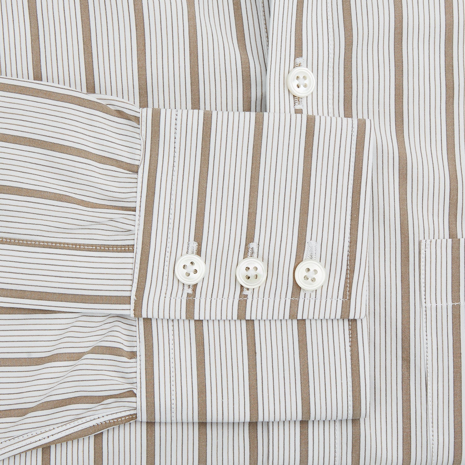 View 3 of product The Turnbull & Asser Brown Multi Track Stripe Chelsea Shirt features long sleeves, multi-track tan stripes, a left chest pocket, and an open T&A collar, shown laid flat on a white background.