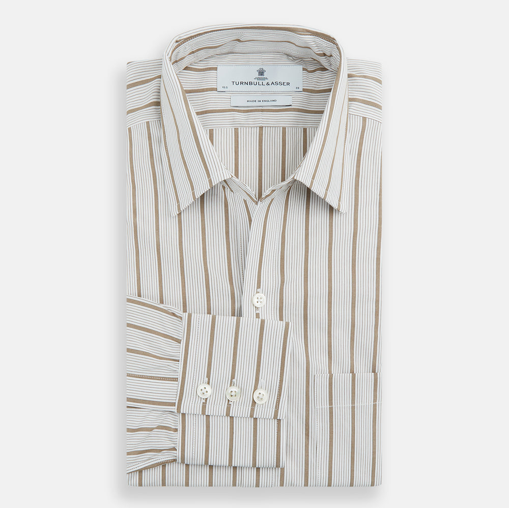 The Turnbull & Asser Brown Multi Track Stripe Chelsea Shirt features long sleeves, multi-track tan stripes, a left chest pocket, and an open T&A collar, shown laid flat on a white background.