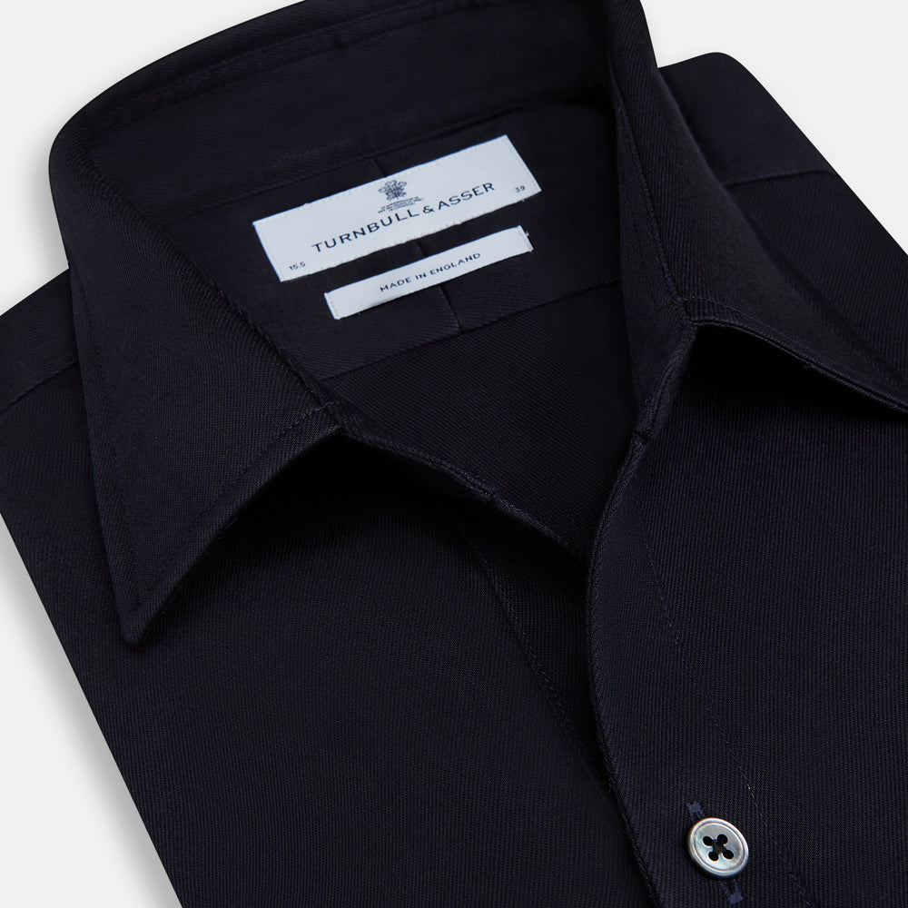 The Turnbull & Asser Navy Twill Chelsea Shirt is a long-sleeve button-up with a collar, front chest pocket, and white buttons, shown against a plain white background.